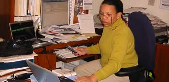 Paula working with 2 computers